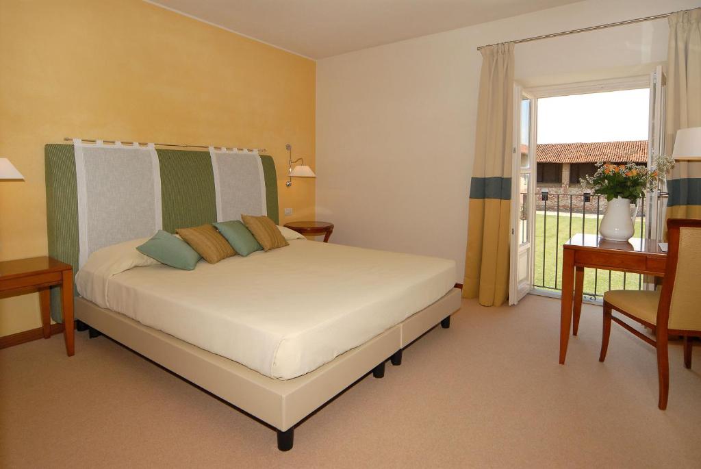 Postel nebo postele na pokoji v ubytování Hotel Antico Podere Propano