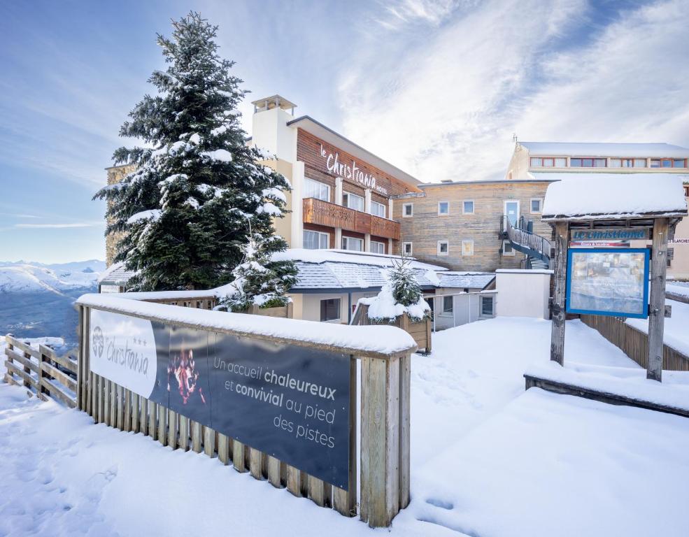 a sign in the snow in front of a hotel at Le Christiania in Saint-Lary-Soulan