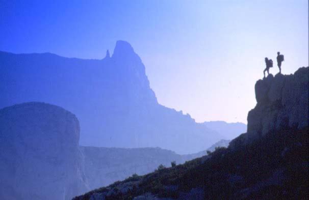 two people standing on top of a mountain at La Petite Calanque in Marseille