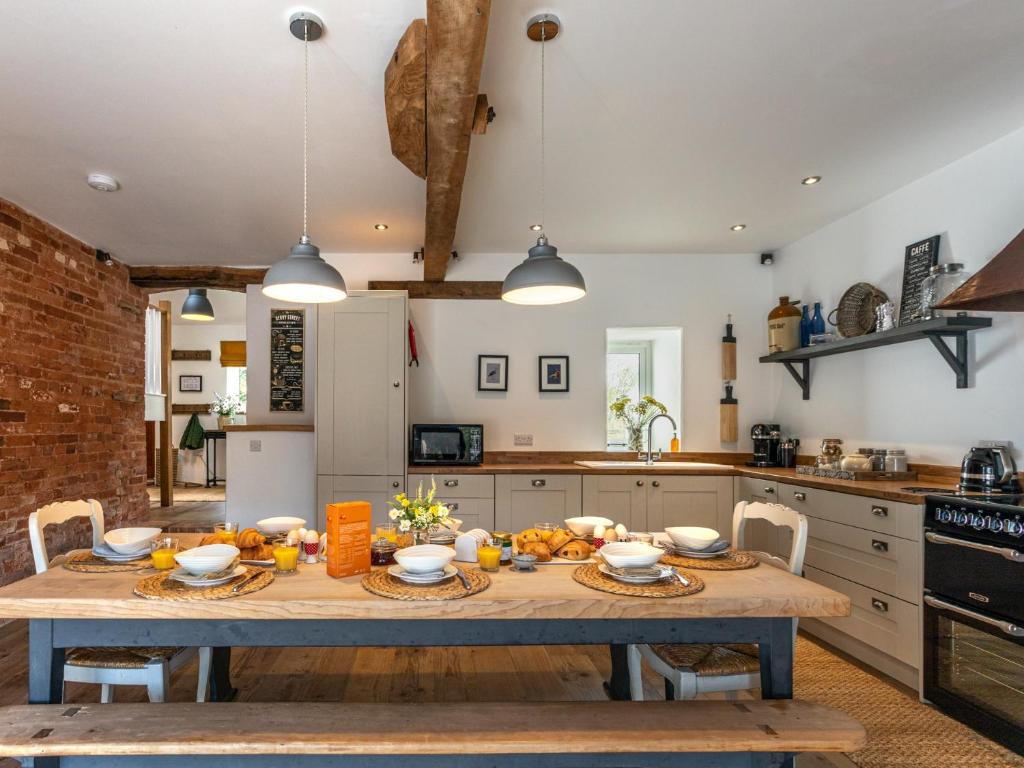 - une cuisine avec une table en bois et de la nourriture dans l'établissement 4 Bed in Sidmouth 45563, à Payhembury