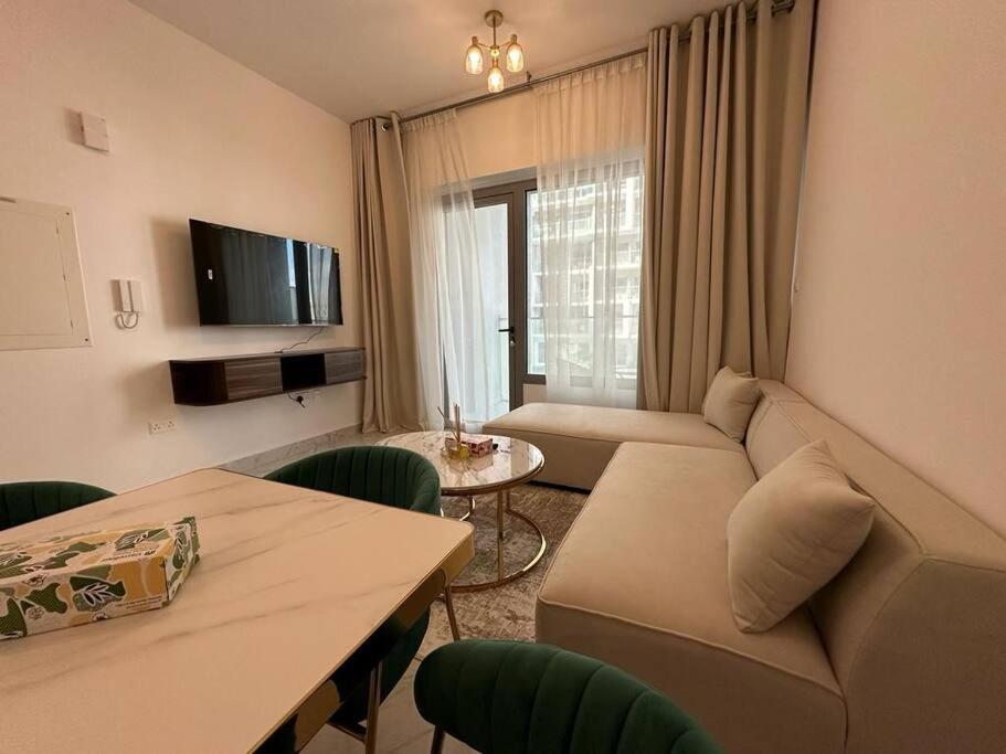 a living room with a couch and a table at Layover in the Green City 203O3 in Al Qurayyah