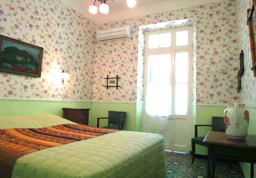 a bedroom with a bed and a window and a desk at La Petite Calanque in Marseille
