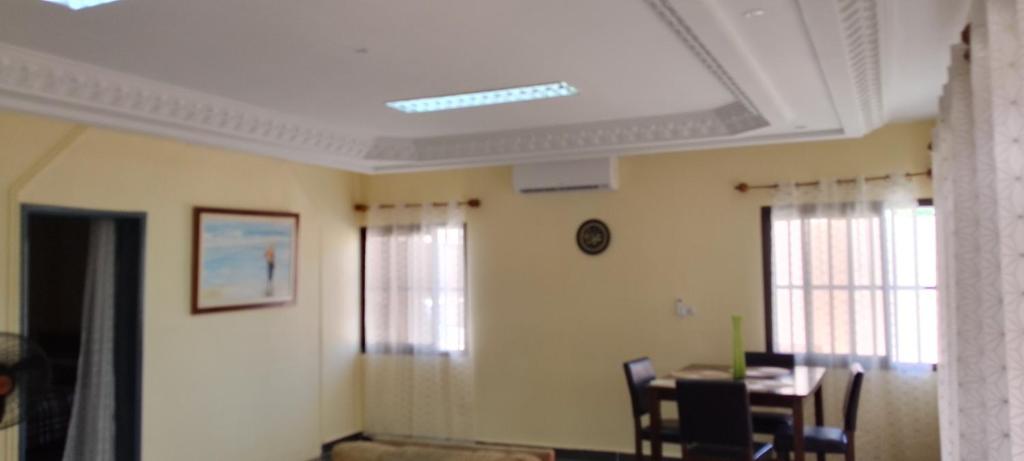 a room with a table and chairs and a ceiling at ADISSA in Cotonou