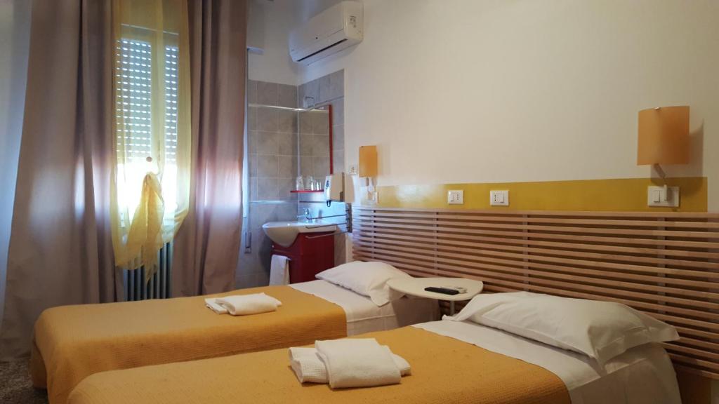 Postel nebo postele na pokoji v ubytování GreenColors Hotel