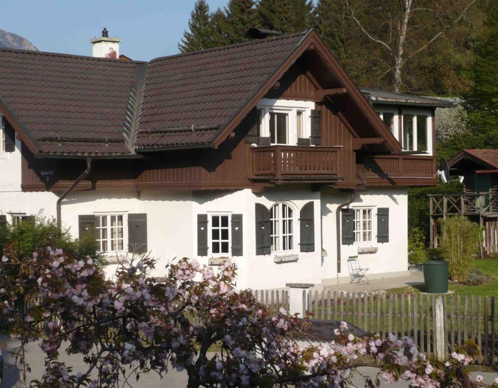 a white house with a wooden roof at Ferienhaus Waxenstein in Garmisch-Partenkirchen