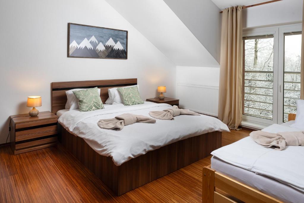 מיטה או מיטות בחדר ב-Apartments Tatra Olla - Tatranská Lomnica