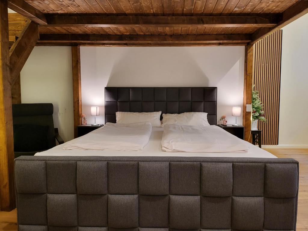 a large bed with a large headboard in a bedroom at Kant 99 XL in Berlin