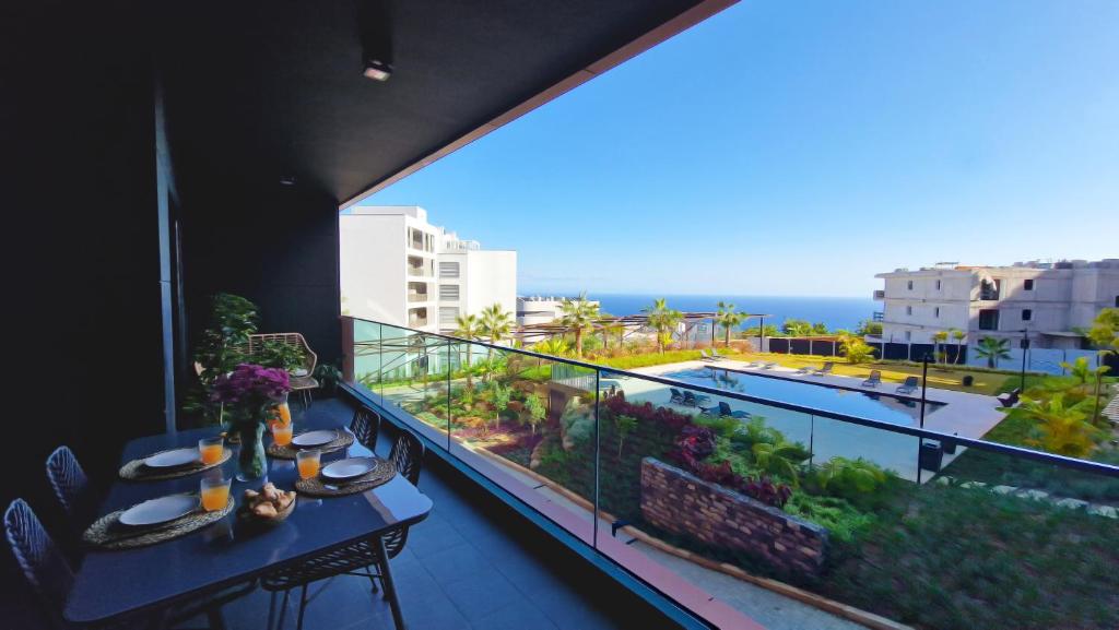 a balcony with a table and a view of the ocean at Roots Loft by LovelyStay in Funchal