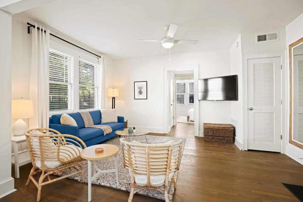a living room with a blue couch and chairs at Cozy Apartment in Virginia Highland in Atlanta
