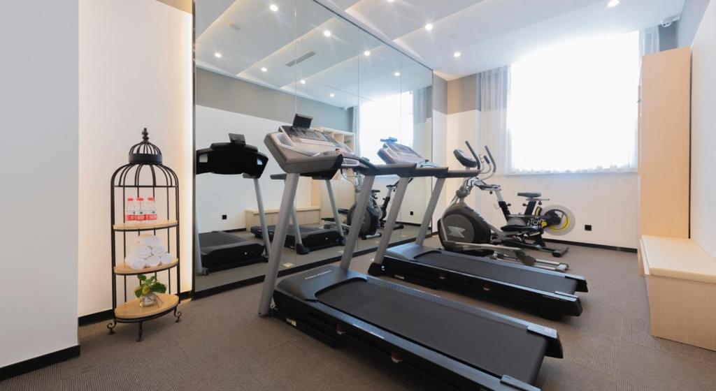 a gym with two exercise bikes and a treadmill at Atour Hotel (Urumqi Renmin Cinema) in Ürümqi