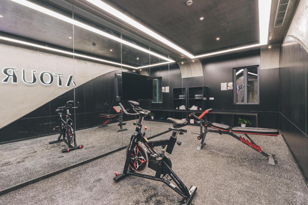 a gym with several exercise bikes in a room at Atour Hotel North Bund Shanghai in Shanghai