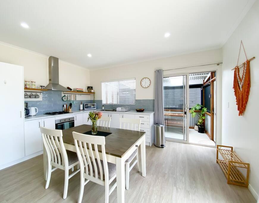 a kitchen with a table and chairs in a kitchen at Augusta House in Bremer Bay