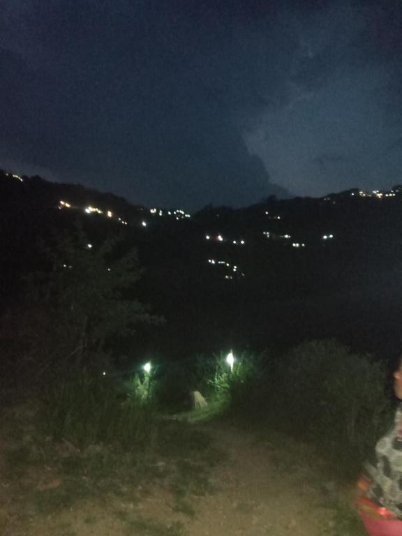 a view of a city at night with lights at Unique point home stay in Nagarkot