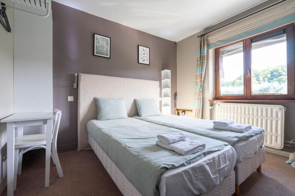 Postel nebo postele na pokoji v ubytování La Vue gîte familial