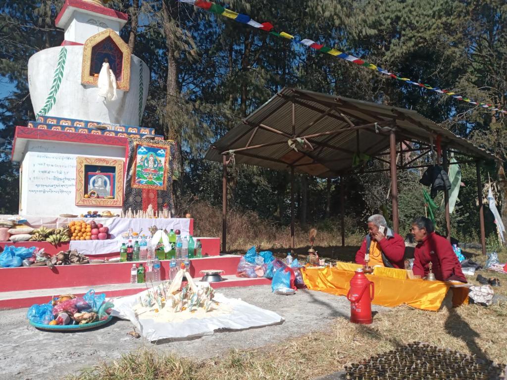 a couple of people sitting in front of a market at Unique point home stay in Nagarkot