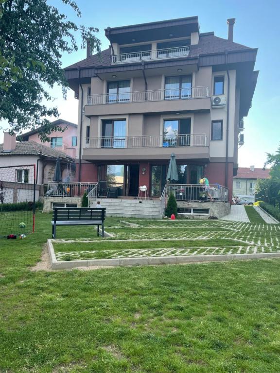 a large building with a bench in front of it at ZaraApartHotel in Sofia