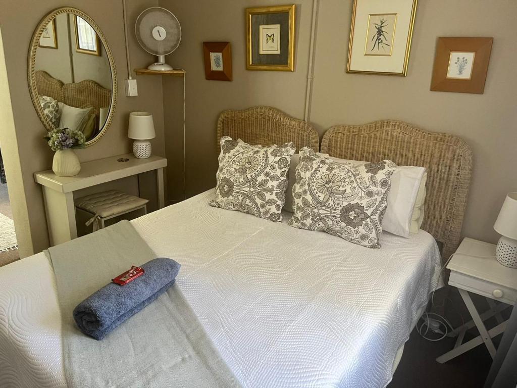 a bedroom with a bed with a blue towel on it at Always Here for you in Krugersdorp