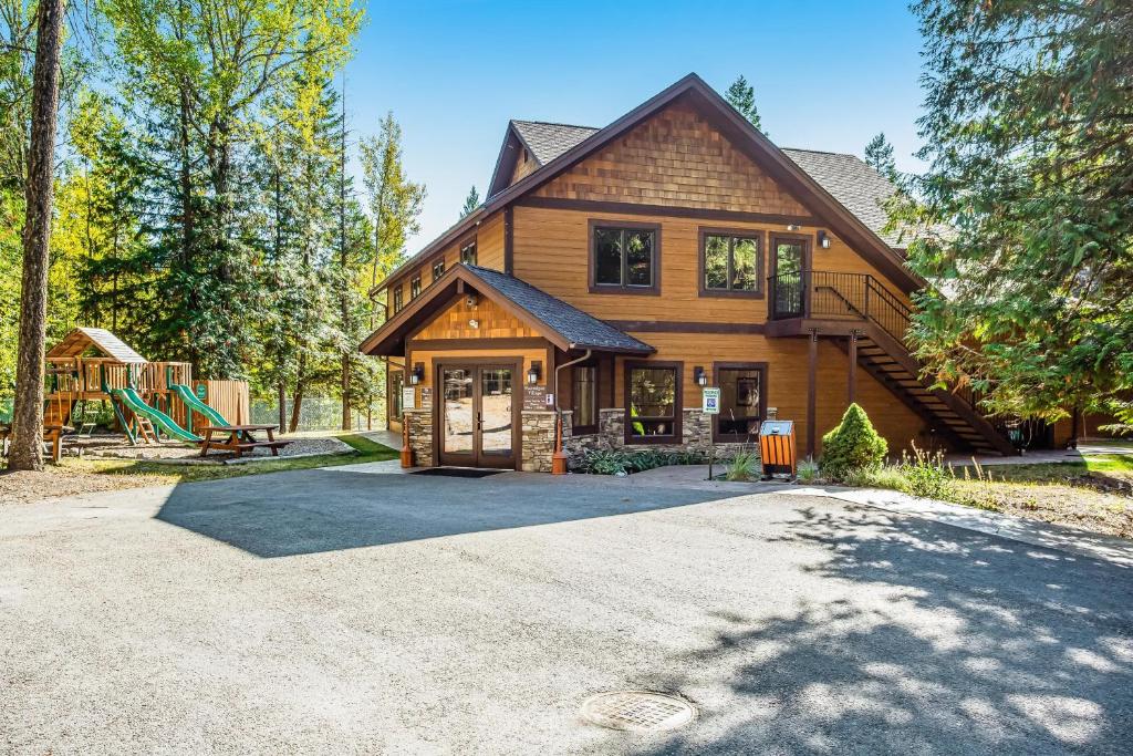 a house with a driveway in front of it at Wooded Dreams in Whitefish