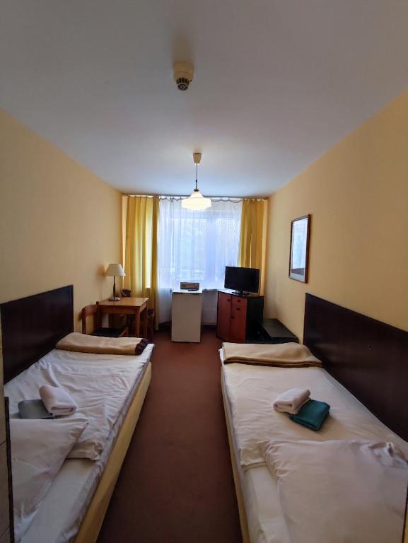 Postel nebo postele na pokoji v ubytování Jantar Economy