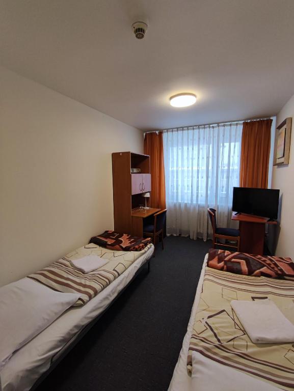 Postel nebo postele na pokoji v ubytování Jantar Economy