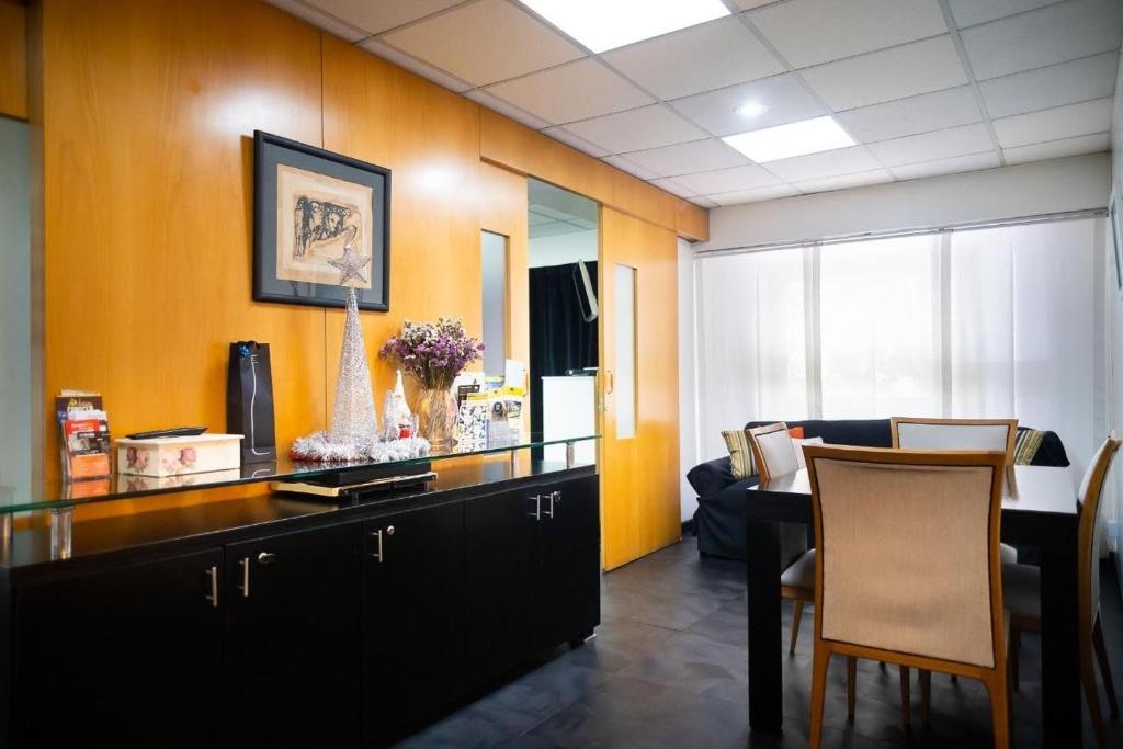 a waiting room with a desk and chairs in a room at Recoleta 1443 Boutique Apartments in Buenos Aires