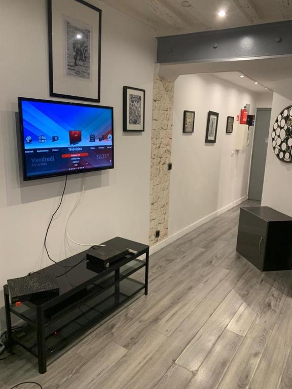 a living room with a flat screen tv on a wall at 15 Atelier Montorgueil Super Héros in Paris