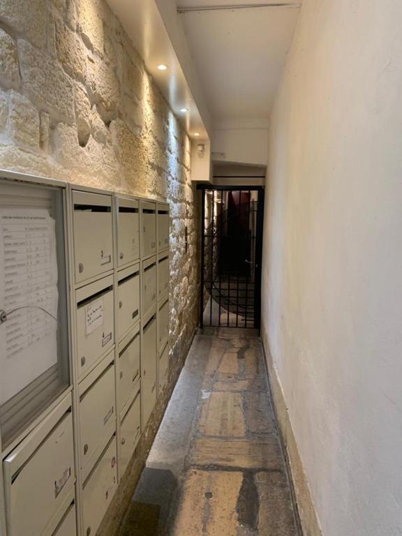 a hallway with lockers and a door in a building at 15 Atelier Montorgueil Super Héros in Paris