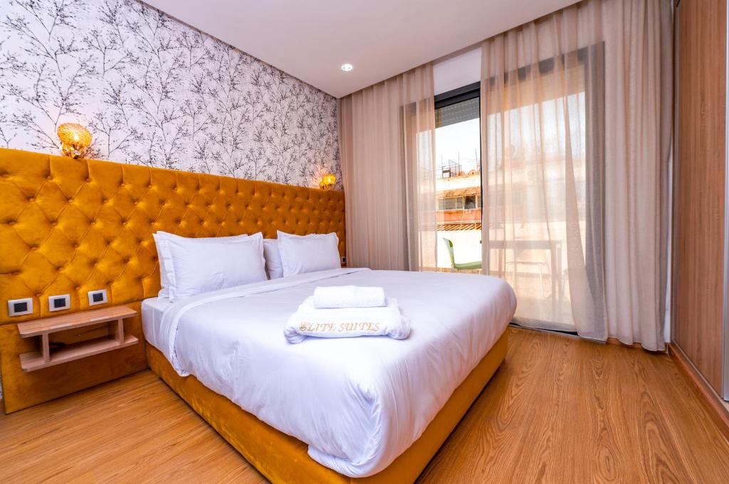a bedroom with a large bed and a large window at Maarif Elite Suites in Casablanca