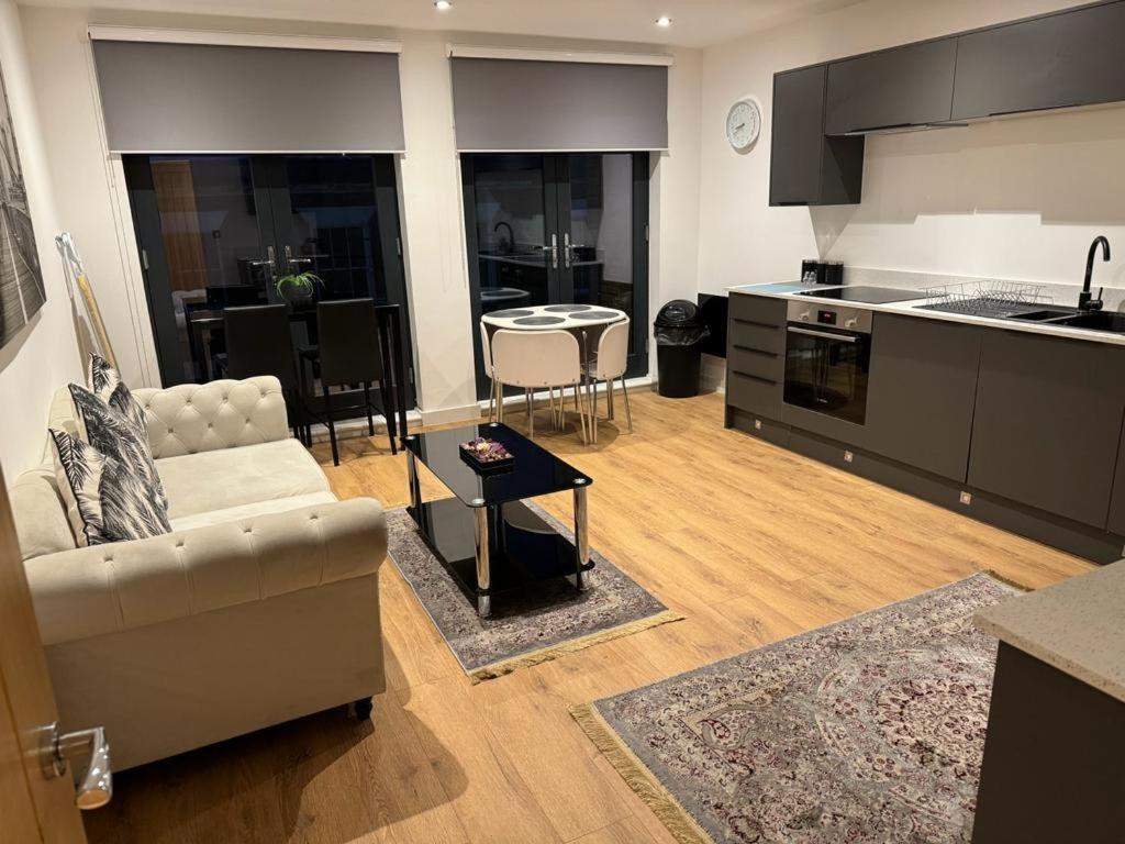 a living room with a couch and a kitchen at Elegant 3 Bed Flat in Ramsgate in Kent