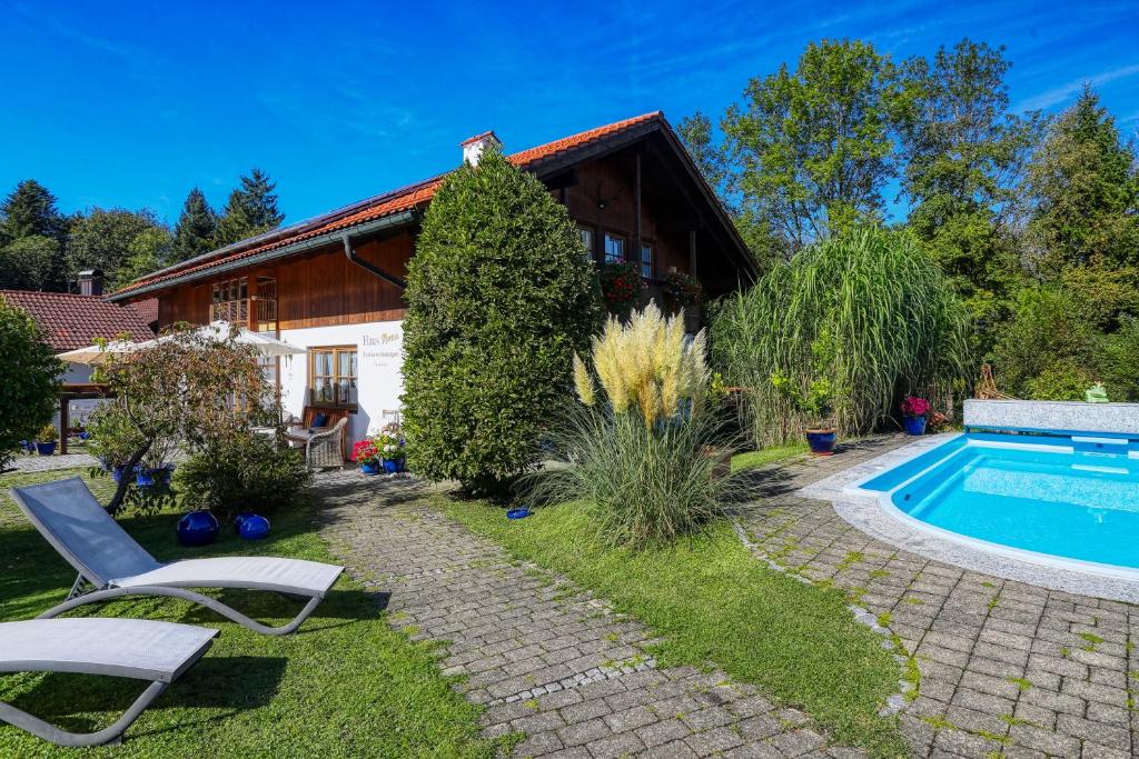 una casa con piscina en un patio en Haus Mona ****, en Bad Heilbrunn