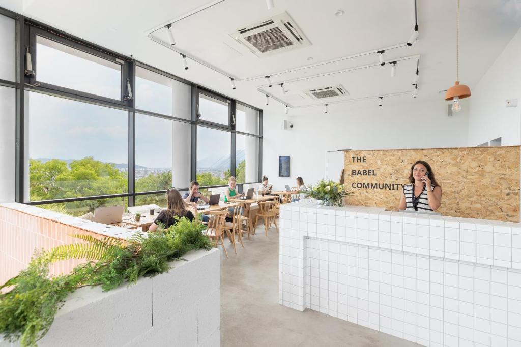 a group of people sitting at tables in a restaurant at Les Appartements de Grenoble in Grenoble