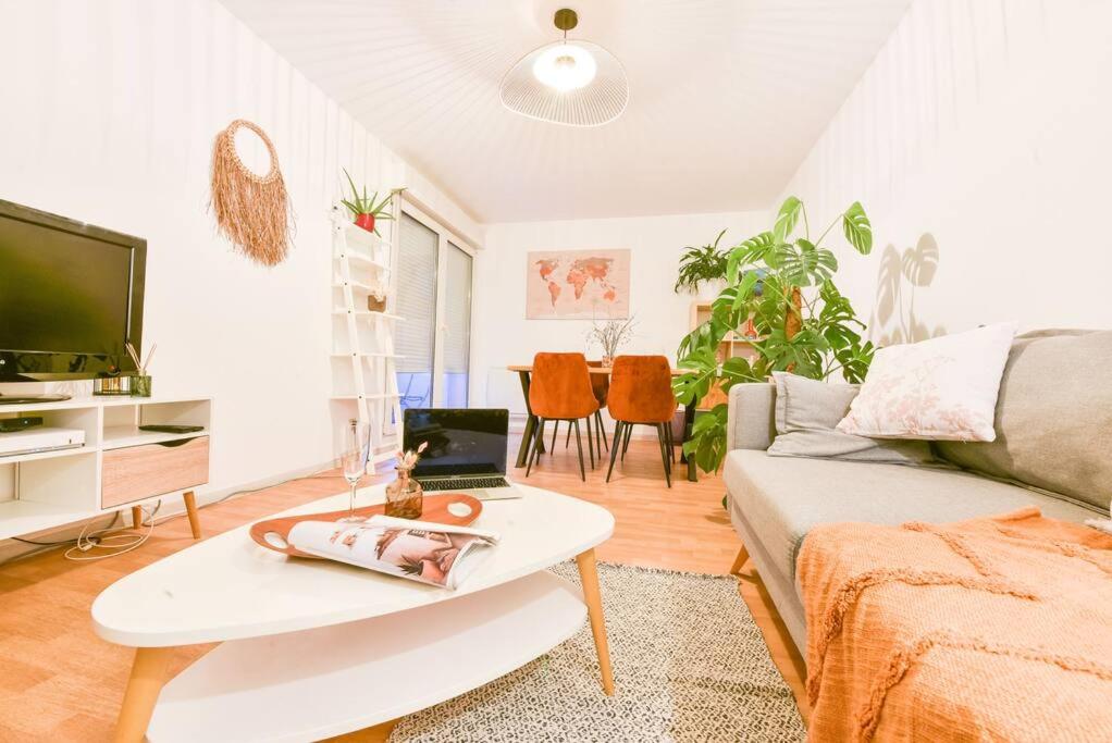 a living room with a couch and a coffee table at Lumineux - Elixir - Parking privé in Strasbourg
