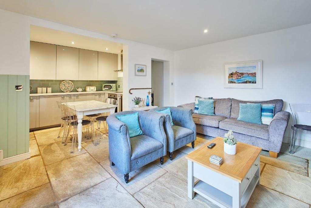 a living room with two couches and a table at Host & Stay - The Courtyard Retreat in Whitby