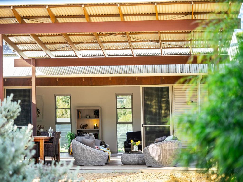a house with a patio with couches and a roof at The Deck in Margaret River Town