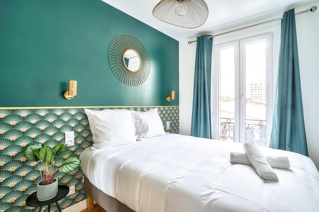 a bedroom with a large white bed and a blue wall at Splendid apartment for 2 persons in Aubervilliers