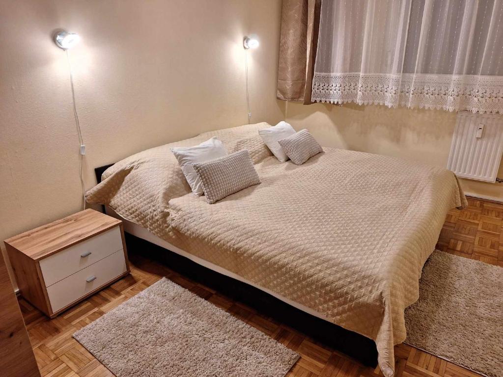 a bedroom with a bed with two pillows and a window at Gvadányi Rezidencia in Budapest