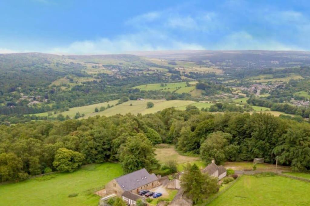an aerial view of a house in a green field at Clarice Cottage in Eyam