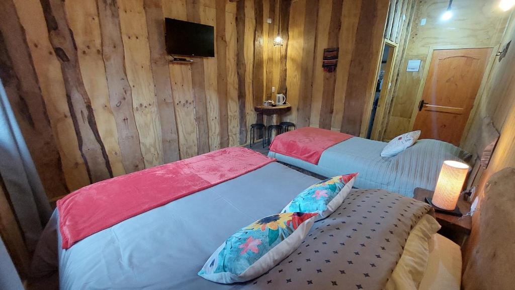 Postel nebo postele na pokoji v ubytování Cabañas & Habitaciones Del Alto