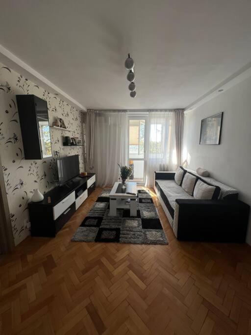a living room with a couch and a table at Bucharest Apartment in Bucharest