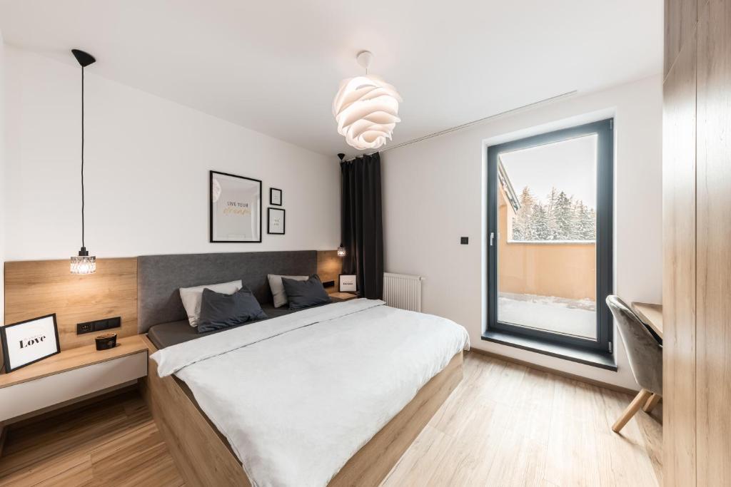 Postel nebo postele na pokoji v ubytování Horem Dolem Apartmán
