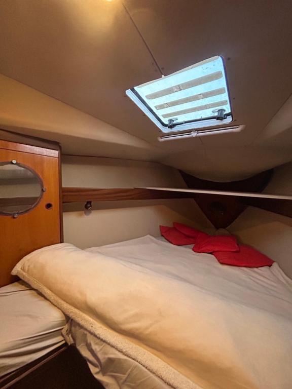 a small room with a bed and a window at Porto Antico Boat in Genova