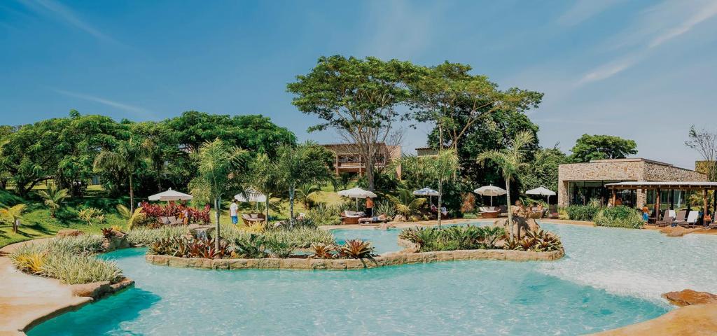 a swimming pool at a resort with a resort at Santa Clara Eco Resort in Dourado