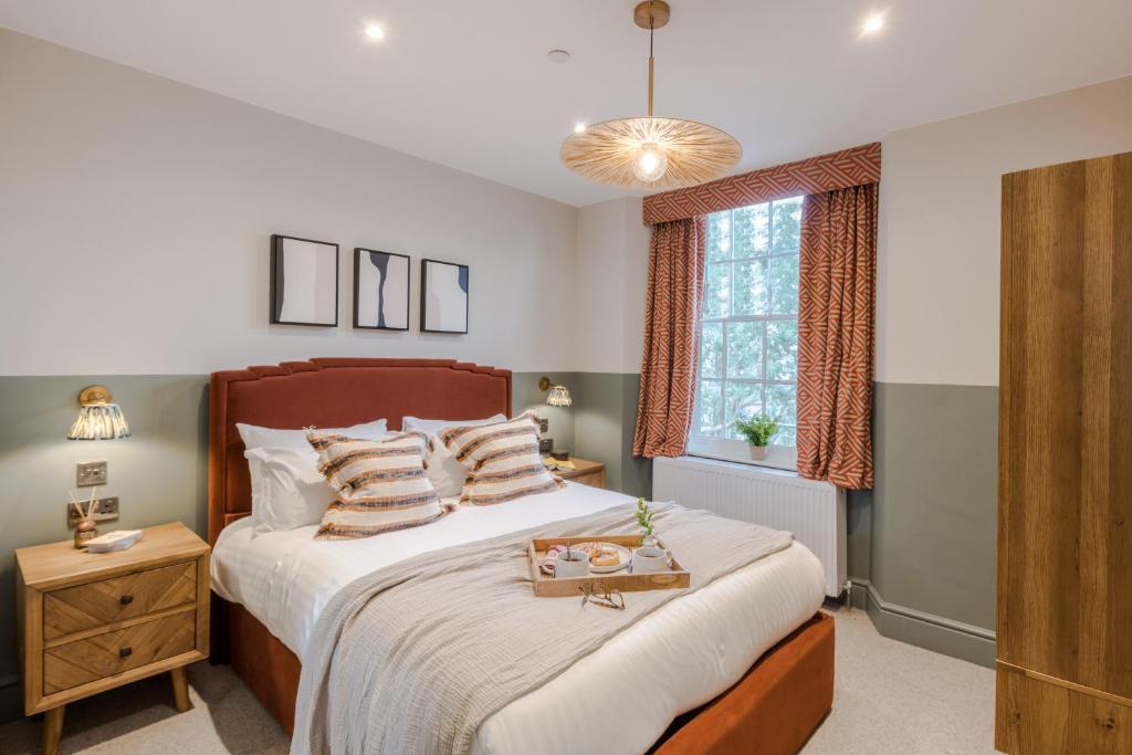 a bedroom with a large bed and a window at Redland Place - Your Apartment in Bristol