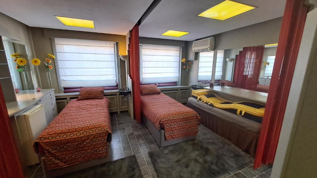 een badkamer met 3 bedden, een wastafel en een bad bij TRIPLE ROOM met 1 of 2 aparte bedden en extra slaapbank in Gullegem
