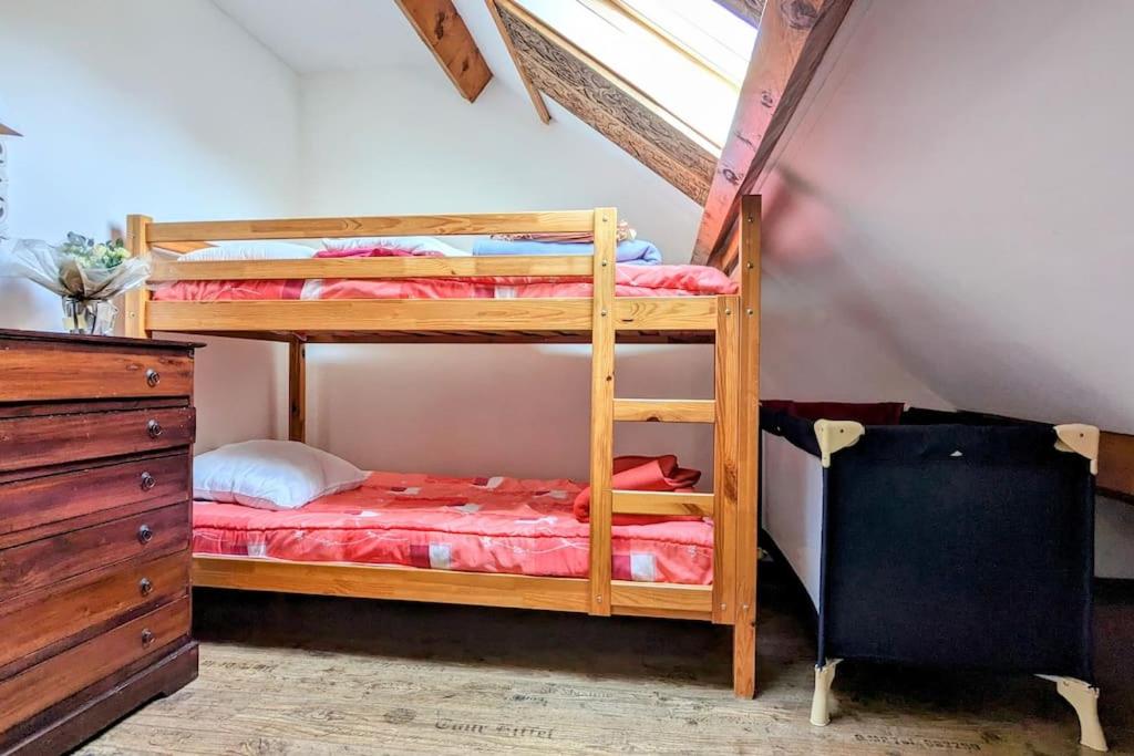 a bedroom with two bunk beds in a attic at Gîte de charme - Normandie in Breteuil-sur-Iton