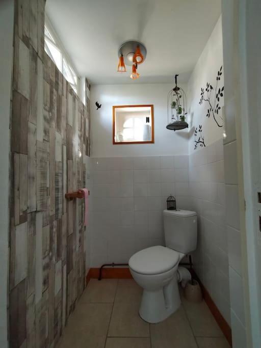 a bathroom with a white toilet in a room at Gîte de charme - Normandie in Breteuil-sur-Iton