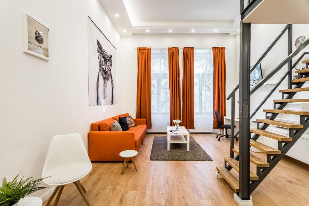 ブダペストにあるGrand Avenue Apartmentのリビングルーム(オレンジ色のソファ、階段付)