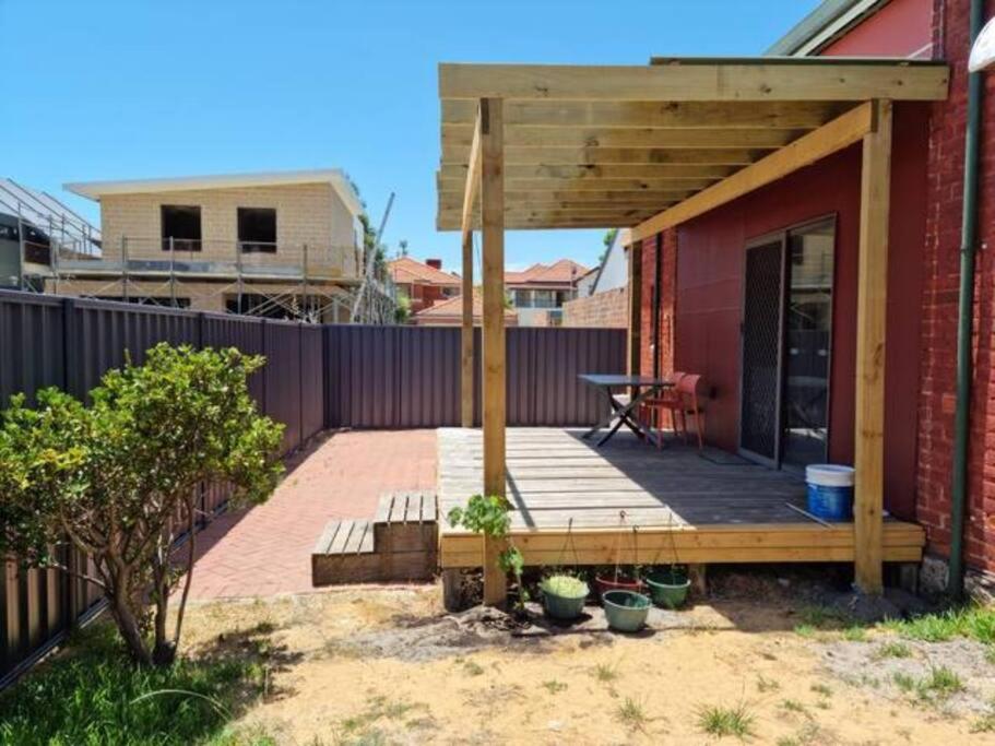 a patio with a wooden pergola on a house at North Perth Stylish Abode CBD in Perth
