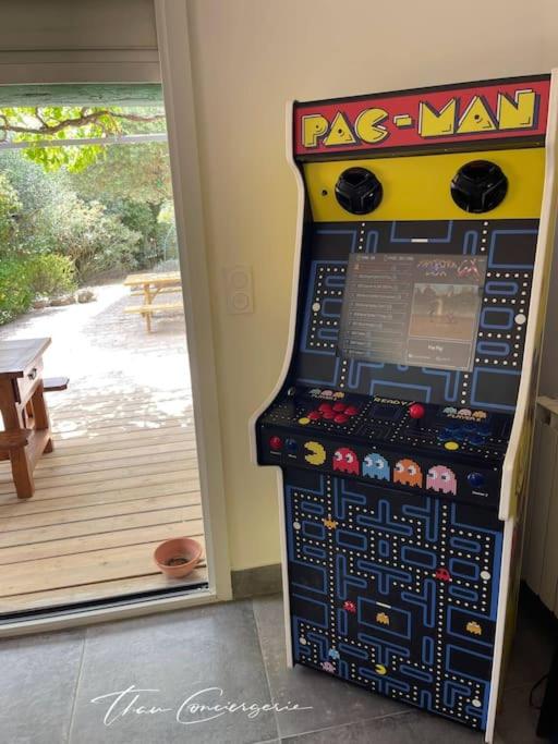 a arcade game machine sitting in front of a door at Poussan, Villa des Oliviers, superbe villa classé in Poussan