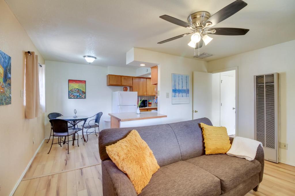 a living room with a couch and a kitchen at Cozy Albuquerque Apartment Less Than 1 Mi to Downtown! in Albuquerque